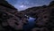 High rock cliffs with the Milky Way galaxy and reflections