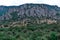 High rock pillars in Valley of Ghosts of the mountain range Demerji, Crimea. Green bushes