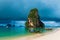 high rock in the sea, rain cloud and Thai boats