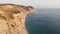 High rock by the sea, view from a drone. Summer landscape, cliff