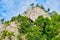 High rock wall with cave, where multi-pitch climbing routes and via ferrata route Dragons Amphitheater are built, in Baia de Fier