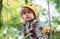 High ropes walk. Helmet and safety equipment. Child concept. Happy Little child climbing a tree. Rope park - climbing