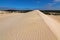 High sand hill ridge with blue sky at Little Sahara white sand d