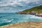 High sandy cliffs and waves of Pacific ocean at Tunnel beach