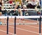 High school boys tied running hurdle race indoors