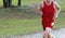 High school cross country runner in red uniform racing on a dirt path