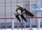 High school female pole vaulter clearing the bar