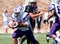 High School Football Player Running with the Ball During a Game