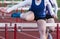 High school girl racing the hurdles