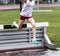 High school girls going over steeplechase barrier into water