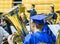 High school graduating senior plays horn in the band in cap and gown