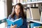 High school student girl reading book at library