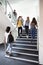 High School Students Walking On Stairs Between Lessons In Busy College Building