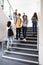 High School Students Walking On Stairs Between Lessons In Busy College Building