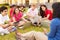 High School Teacher Sitting Outdoors With Students On Campus