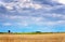 High seat of the hunter on a harvested field in autumn. Clouds over the field