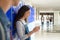 High shool girl using smartphone near locker