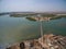 High shot of the sea with a bridge on it surrounded by islands greenery and buildings in Senegal