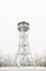 High, snow-covered lookout tower on the top of the Jagodna mountain, winter season