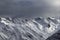 High snowy mountains and sunlight storm sky in evening