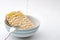 High sodium food, quick snack and meal in minutes concept with hot water pouring over instant noodles in a ceramic bowl isolated