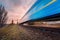 High speed blue passenger train on railroad track in motion