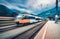 High speed orange train in motion on the railway station