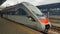 The high-speed passenger electric train Hyundai Rotem Tarpan HRCS2 Intercity stands on the platform of the central railway station