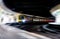 High speed passenger train rushing through train station speeding motion blur not stopping for passengers travellers and commuters