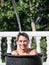 High-speed photograph that captures the impact of water by hitting the face of a teenage boy inside a bucket