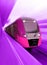 high-speed purple passenger train passes the railway platform