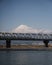 High-speed Shinkansen train over Fuji river with a mesmerizing Fuji mountain on the background