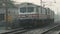 High speed train engine running on railroad track located in Delhi, India during sunset in summer season, Indian Railways locomoti