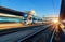 High speed train in motion at the railway station at sunset