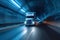 High speed transport semi truck dashes through tunnel, leaving motion blur