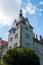 A high spire with a clock on the wall of the hunting estate of Count Schenborn. Carpathians. Ukraine