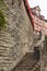 High stone wall with a long stairway to some old medieval houses