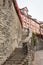 High stone wall with a long stairway to some old medieval houses