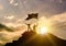 High success, family three silhouette, father of mother and child holding flag of victory on top of mountain, hands up.