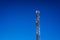 High telecommunications tower, with antennas for mobile phones creating radio cells, copy space