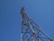 High television antenna on a background of the blue sky