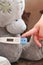 High temperature on an electronic thermometer. bear with a thermometer. baby temperature