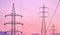 High tension pylons and hanging cables with colored sky