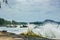 High tide waves flood over beach wall, Phuket, Thailand