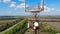 High tower with satellites and cables on a field.