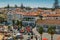 High vantage point of busy tourist traffic near the sandy Praia do Ribeiro and boats on bay a a sunny summer day. Cascais is a sma