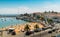 High vantage point of crowded sandy Praia do Ribeiro and boats on bay a a sunny summer day. Cascais is a small quaint village 30km