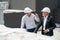 High view of two engineer or technician workers discuss together on rooftop of constuction site