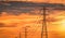 High voltage electric pole and transmission line in the evening. Electricity pylons at sunset. Power and energy. High voltage grid