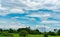 High voltage electric pylon and electrical wire with blue sky and white clouds. Tall electricity pole. Power and energy concept.